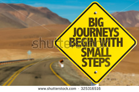 stock-photo-big-journeys-begin-with-small-steps-sign-on-desert-road-325316516